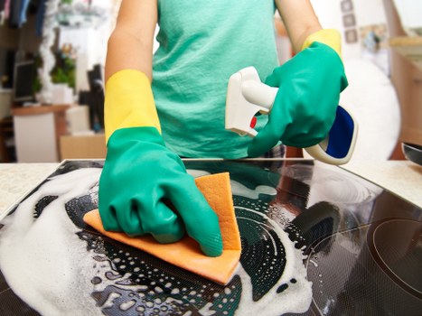 Office cleaning team sanitising desks and shared surfaces in Barnes